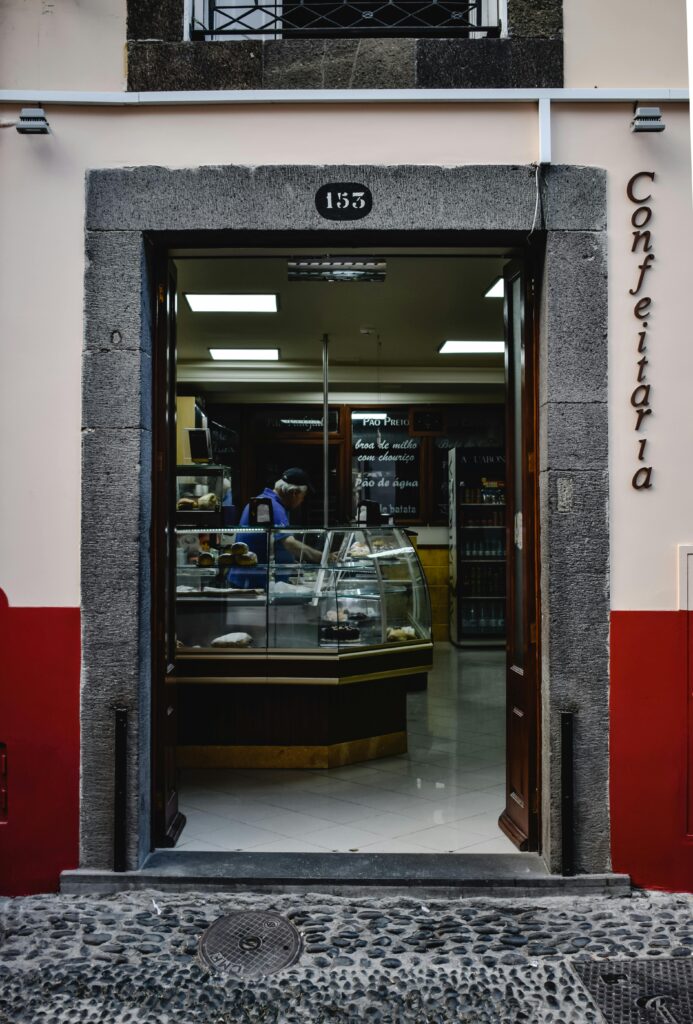 Entrance of a traditional Portuguese confeitaria showcasing pastries.